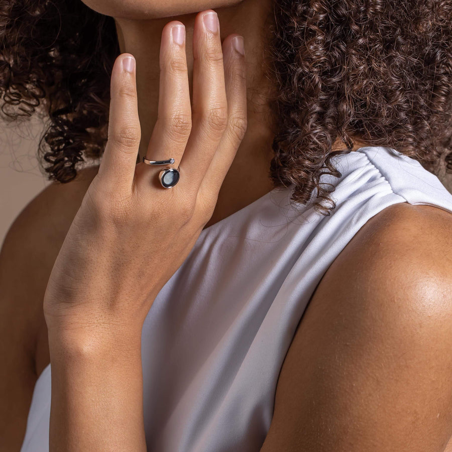 Woman wearing moon phase Cosmic Spiral Ring in Rhodium